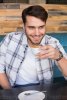 young-man-having-cup-of-coffee-photo.jpg